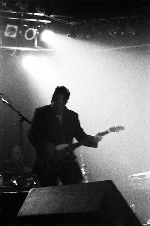 Gord Downie performing energetically with The Tragically Hip